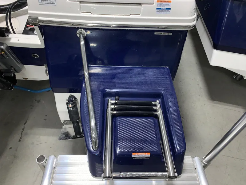 Slide: The Image of 2024 Robalo 246 Cayman boat with a folded ladder and blue deck. - 4