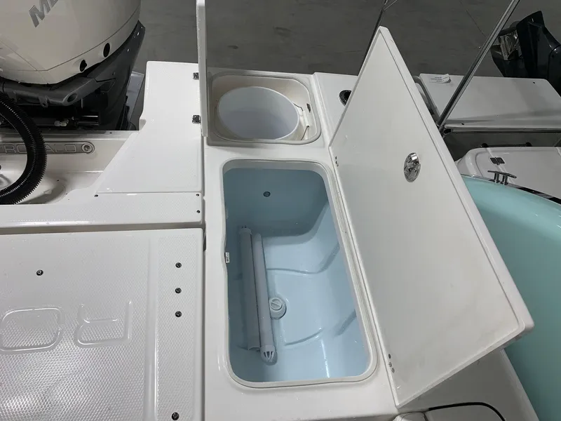Slide: The Image of 2024 Robalo 246 Cayman boat storage compartments and livewell. - 6