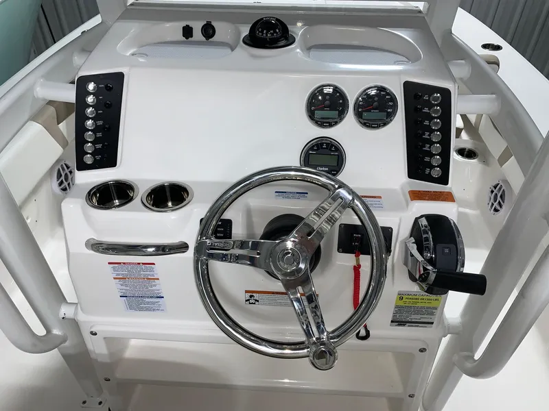 Slide: The Image of 2024 Robalo 246 Cayman boat console with steering wheel and control panel. - 11
