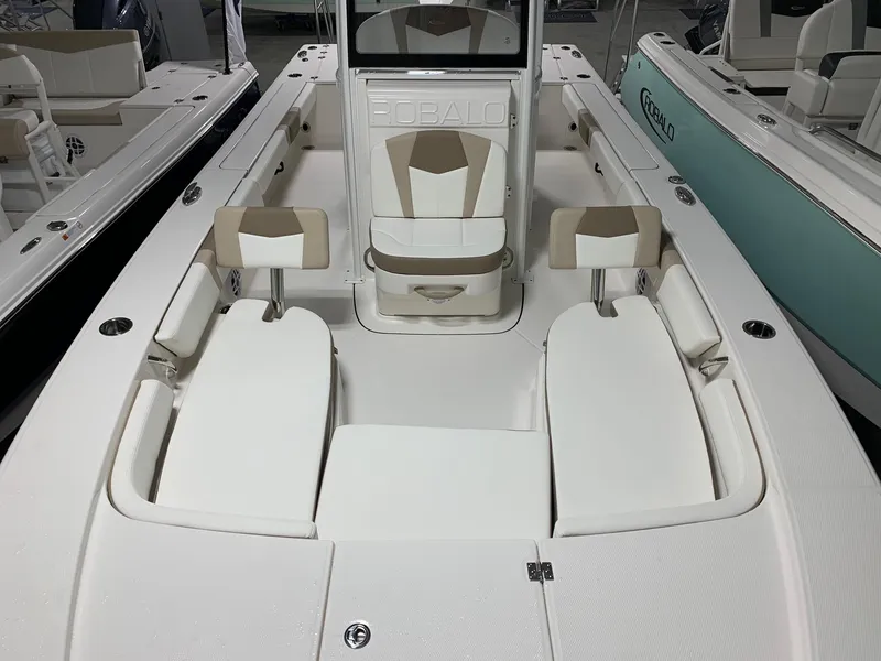 Slide: The Image of 2024 Robalo 246 Cayman boat interior with white and beige seating. - 4