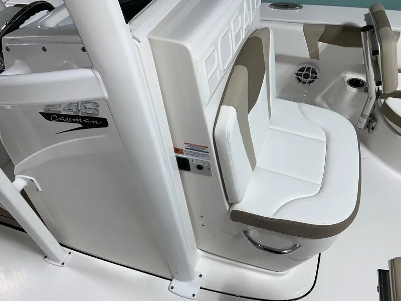 Slide: The Image of 2024 Robalo 246 Cayman boat interior with white and beige seating. - 8