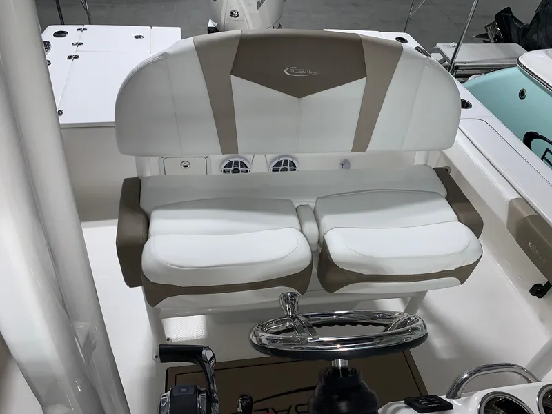 Slide: The Image of 2024 Robalo 246 Cayman boat interior with dual seating and steering wheel. - 9