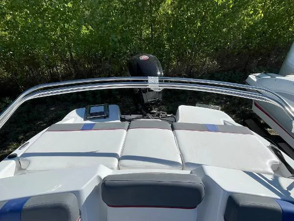 Slide: The Image of 2022 Tahoe T18 boat with cushioned seating and outboard motor. - 6