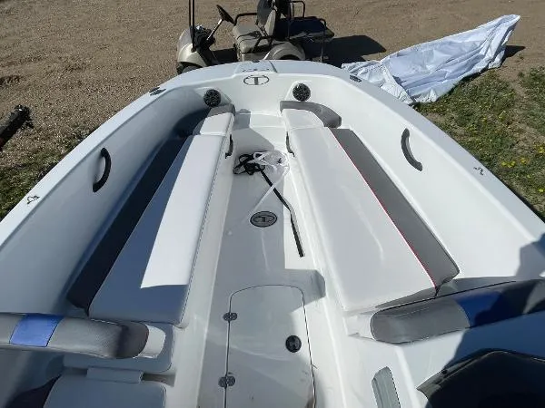 Slide: The Image of 2022 Tahoe T18 boat interior with white and gray seating. - 7