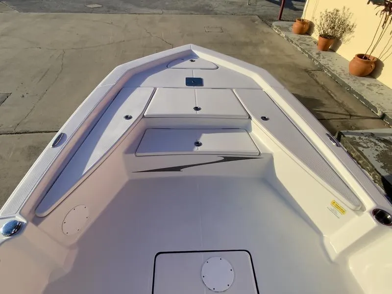 Slide: The Image of 2022 Blue Wave 2200 STL boat on trailer, parked outside a building. - 3