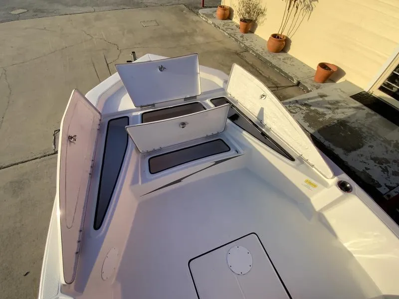 Slide: The Image of Red 2022 Blue Wave 2200 STL boat on trailer in front of building. - 4