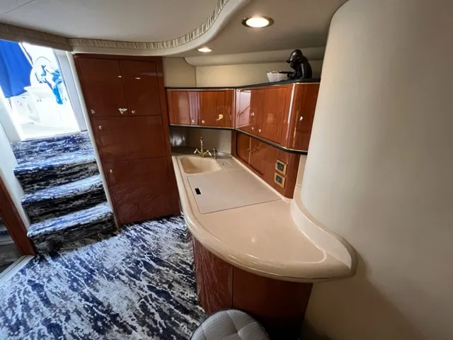 Slide: The Image of Interior of 2000 Sea Ray 460 Sundancer yacht with kitchenette and stairs. - 11
