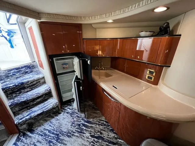 Slide: The Image of Interior of 2000 Sea Ray 460 Sundancer yacht with kitchenette and open fridge. - 12