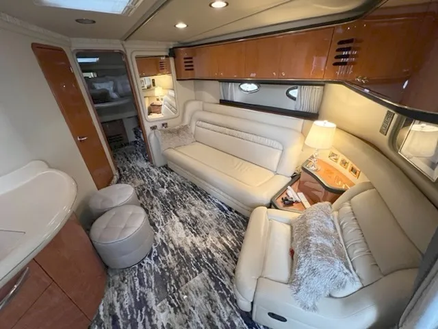 Slide: The Image of Interior of a 2000 Sea Ray 460 Sundancer yacht with plush seating and modern decor. - 13