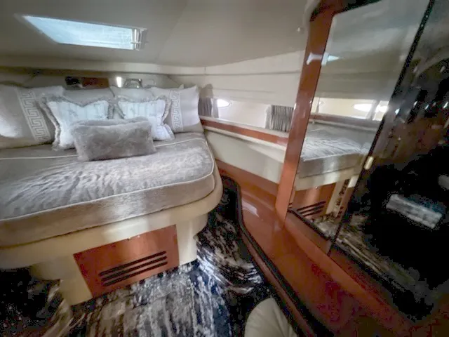 Slide: The Image of Luxurious bedroom interior of 2000 Sea Ray 460 Sundancer yacht with plush bedding. - 14