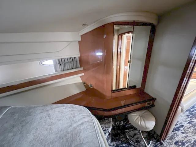 Slide: The Image of Interior cabin of 2000 Sea Ray 460 Sundancer yacht with wooden vanity and mirror. - 16