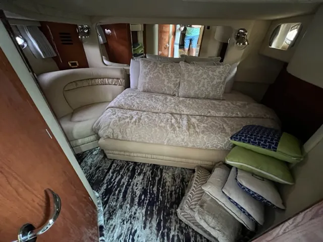 Slide: The Image of Luxurious bedroom interior of 2000 Sea Ray 460 Sundancer yacht with plush bedding and cushions. - 20