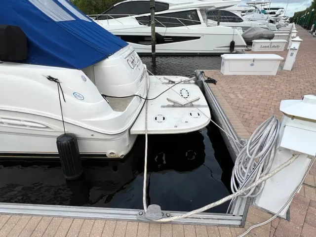 Slide: The Image of Sea Ray 460 Sundancer 2000 docked at marina with blue cover and mooring lines. - 3