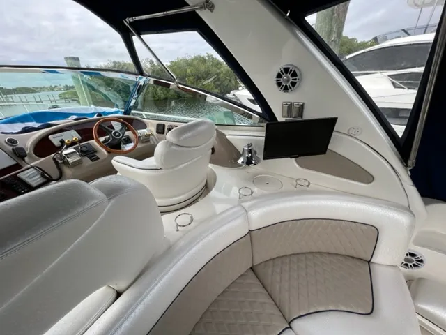 Slide: The Image of Interior of 2000 Sea Ray 460 Sundancer yacht with white leather seating and helm station. - 6