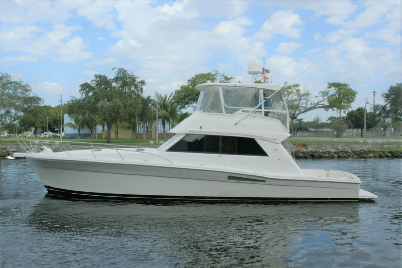 The Image of 2000 Riviera 48 Convertible yacht on calm water. - 0