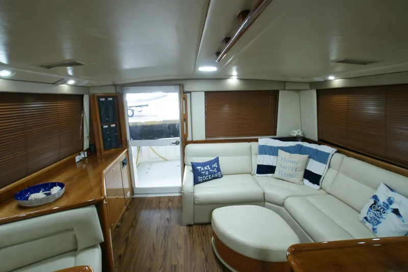 Slide: The Image of Interior of 2000 Riviera 48 Convertible yacht with cozy seating area. - 1