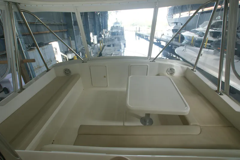Slide: The Image of Interior of a 2000 Riviera 48 Convertible yacht with table and seating area. - 10