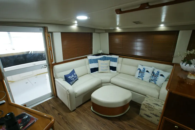 Slide: The Image of Interior of a 2000 Riviera 48 Convertible yacht with cozy sofa and cushions. - 2