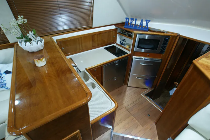 Slide: The Image of Interior of Riviera 48 Convertible yacht, kitchen with wood finish. - 4