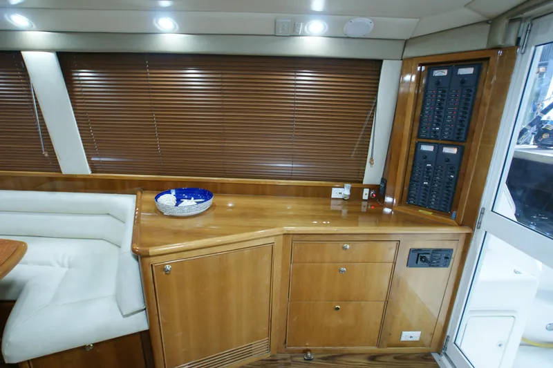 Slide: The Image of Interior of 2000 Riviera 48 Convertible with wood cabinetry and control panel. - 7