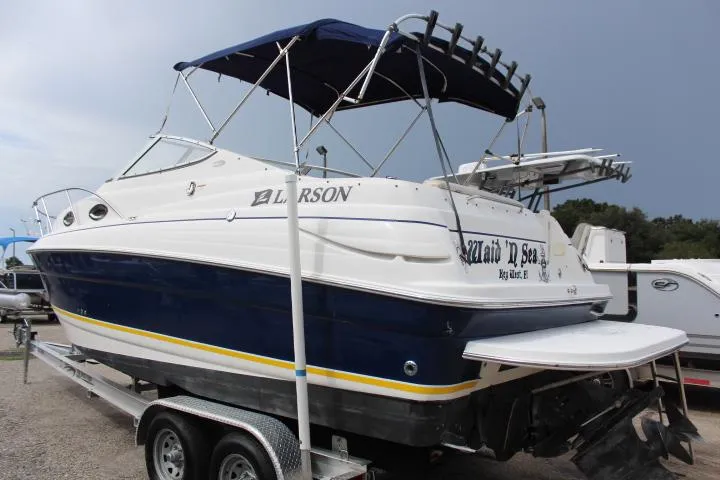 Slide: The Image of 2005 Larson Cabrio 240 boat on trailer with blue and white exterior. - 1