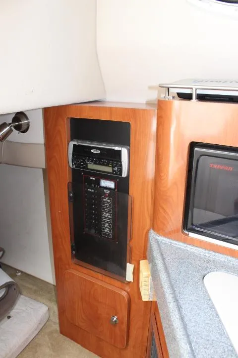 Slide: The Image of 2005 Larson Cabrio 240 interior cabin with control panel and microwave. - 12