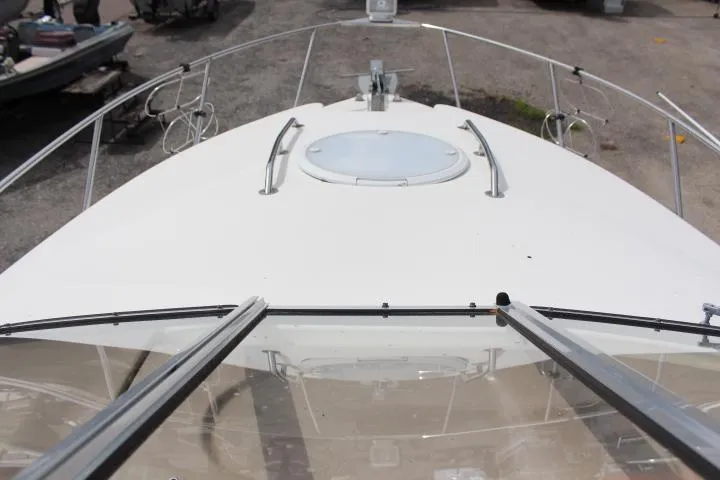 Slide: The Image of 2005 Larson Cabrio 240 boat deck with hatch and railing. - 16