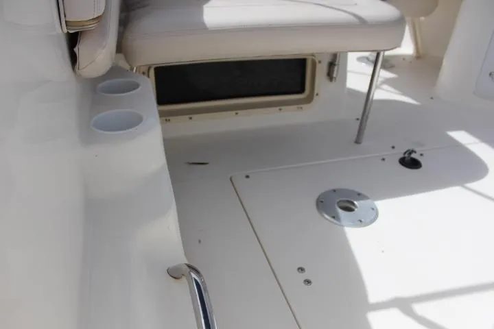 Slide: The Image of Interior of a 2005 Larson Cabrio 240 boat with seating and cup holders. - 23