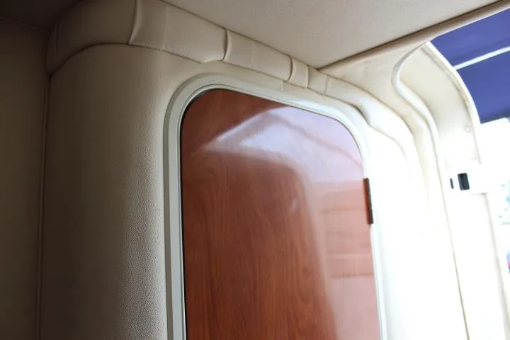 Slide: The Image of Interior cabin door of a 2005 Larson Cabrio 240 boat. - 9