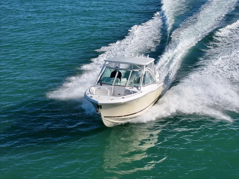 Slide: The Image of 2022 Albemarle 27 DC boat cruising on a serene blue lake. - 0