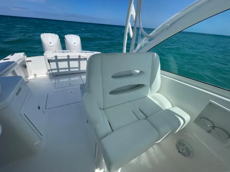 Slide: The Image of 2022 Albemarle 27 DC boat cruising on open ocean under clear blue sky. - 13