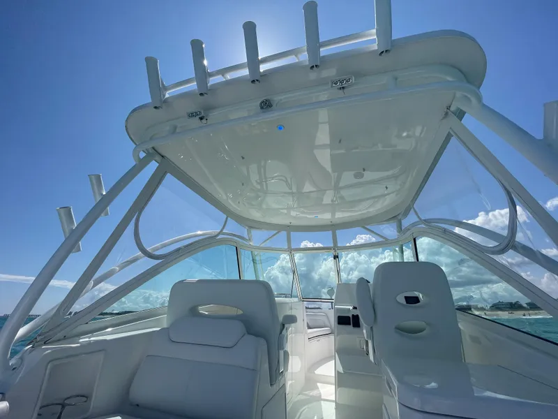 Slide: The Image of 2022 Albemarle 27 DC boat cruising on open ocean under clear blue sky. - 14