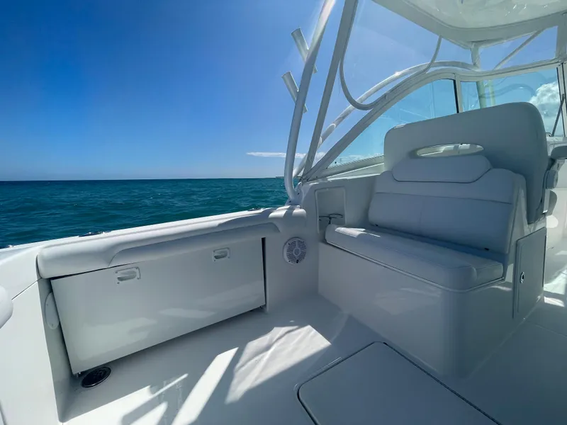 Slide: The Image of 2022 Albemarle 27 DC boat cruising on open ocean under clear blue sky. - 15