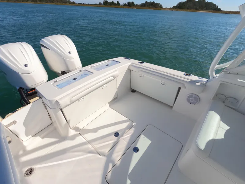 Slide: The Image of 2022 Albemarle 27 DC boat with dual outboard engines on a sunny day. - 27