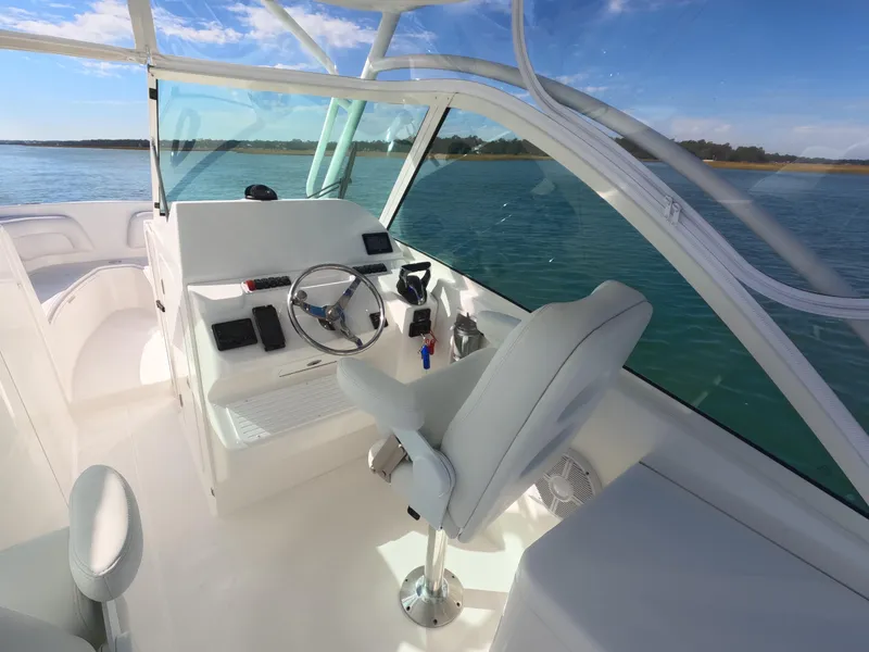 Slide: The Image of Control panel on 2022 Albemarle 27 DC boat, featuring modern switches and dials. - 28