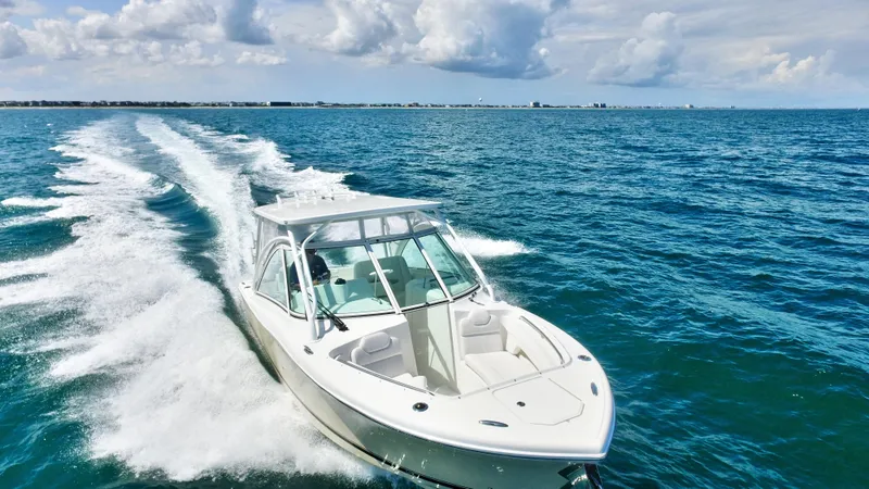 Slide: The Image of 2022 Albemarle 27 DC boat cruising on open water. - 3