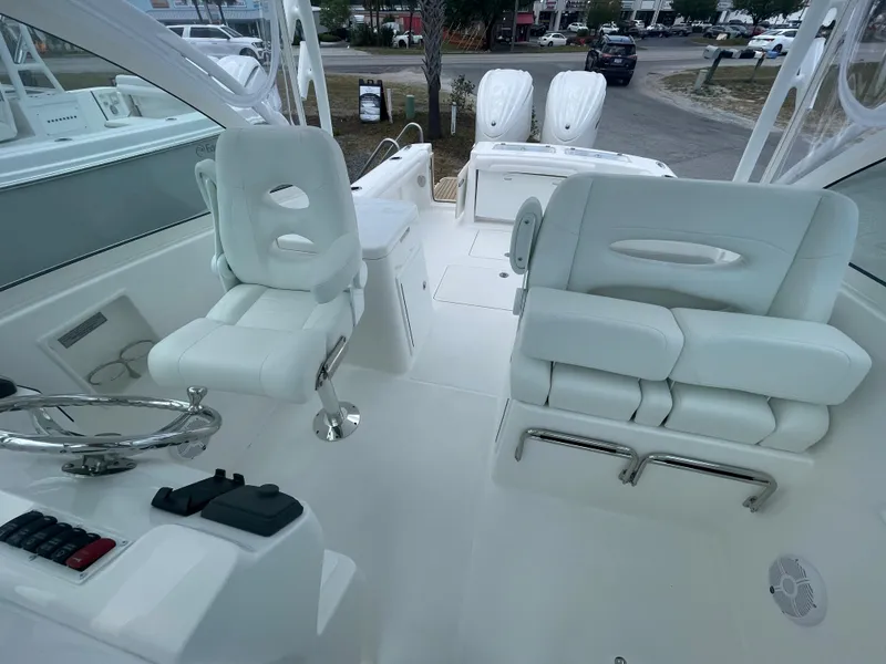 Slide: The Image of 2022 Albemarle 27 DC boat cockpit with steering wheel and navigation controls. - 36