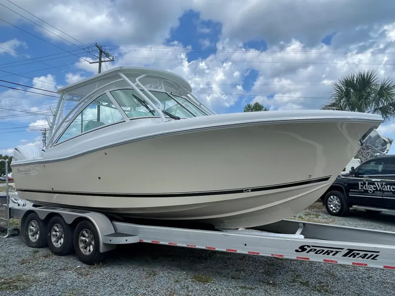 Slide: The Image of Luxury helm seat on 2022 Albemarle 27 DC boat with teak flooring. - 37