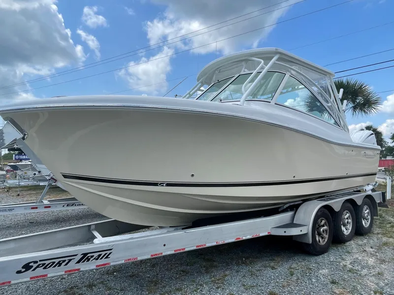 Slide: The Image of Captain's chair on 2022 Albemarle 27 DC boat, overlooking water with sleek interior design. - 38