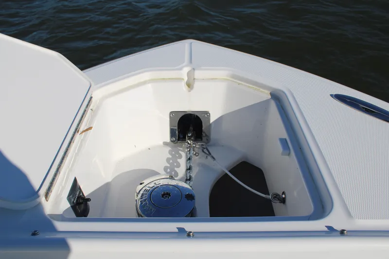 Slide: The Image of Anchor compartment of 2022 Albemarle 27 DC boat, featuring a neatly coiled anchor chain. - 45