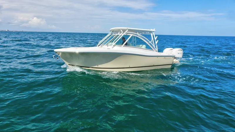 Slide: The Image of 2022 Albemarle 27 DC boat on water, aerial view, white exterior, dual engines. - 5