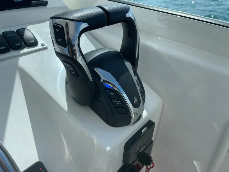 Slide: The Image of 2022 Albemarle 27 DC boat cruising on a sunny day in open water. - 8