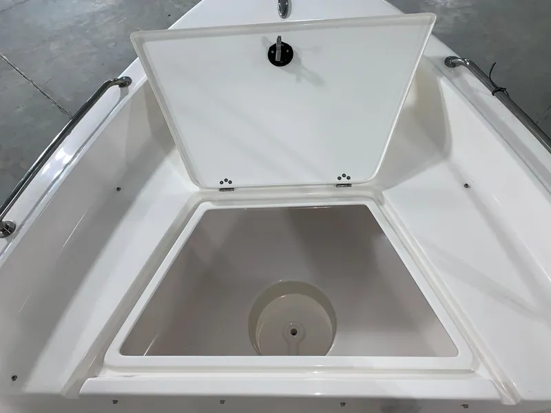 Slide: The Image of 2024 Key West 1720 Sportsman boat storage compartment with open lid. - 12
