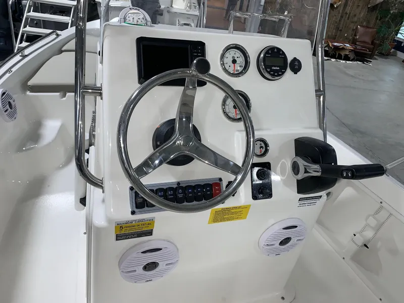 Slide: The Image of 2024 Key West 1720 Sportsman boat dashboard with steering wheel and control panel. - 16