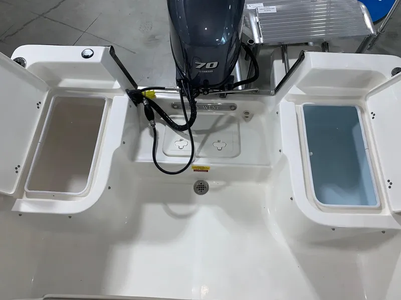 Slide: The Image of 2024 Key West 1720 Sportsman boat stern with open storage compartments and outboard motor. - 3