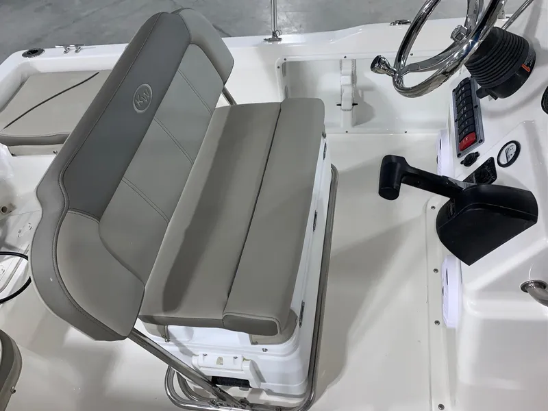 Slide: The Image of 2024 Key West 1720 Sportsman boat interior with steering wheel and cushioned seating. - 8