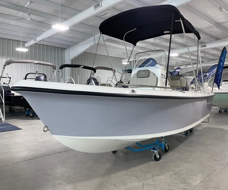 Slide: The Image of 2024 Key West 1720 Sportsman boat in showroom with black canopy. - 1