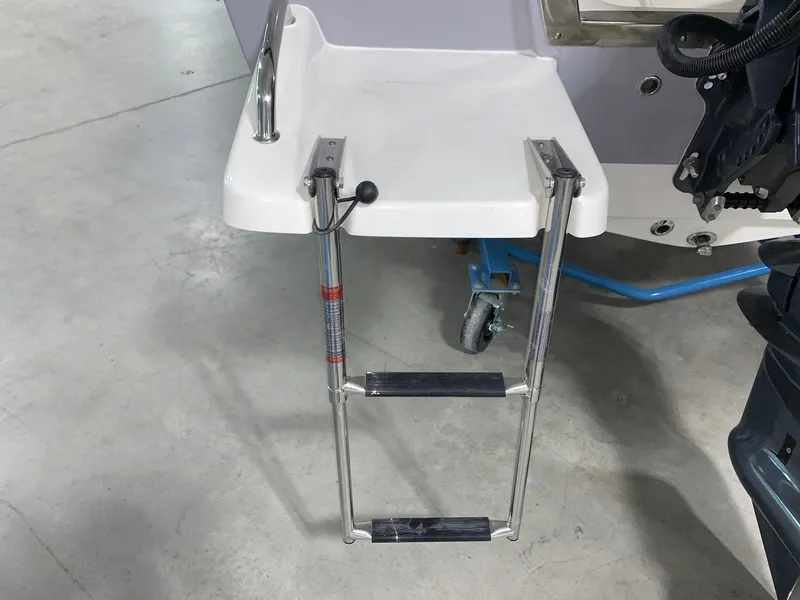 Slide: The Image of 2024 Key West 1720 Sportsman boat with a foldable swim ladder. - 2