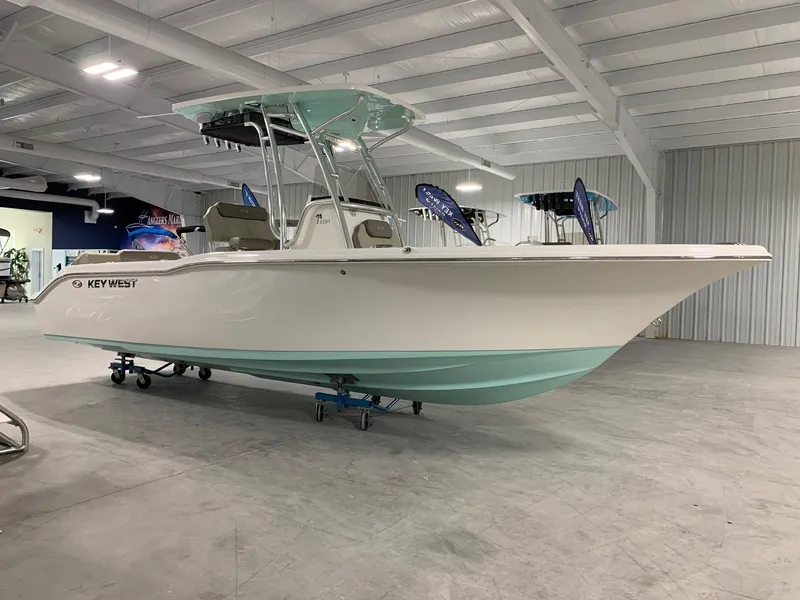 The Image of 2024 Key West 239 FS boat in showroom, white and mint green hull. - 0