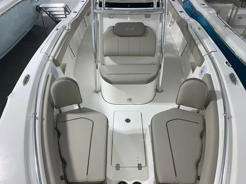Slide: The Image of 2024 Key West 239 FS boat interior with cushioned seating and storage compartments. - 16